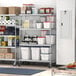 A Regency stainless steel shelving unit in a kitchen with food items on the shelves.