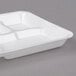 A white styrofoam Genpak school tray with 5 compartments.