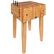 A John Boos maple butcher block with knives on top.