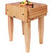 A John Boos maple butcher block with a knife on it.