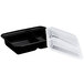 A black Pactiv VERSAtainer plastic container with two compartments and a clear lid.