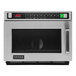 A silver Amana commercial microwave with a black door.