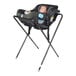 A baby in a Koala Kare black infant seat on a stand.