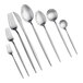 A close-up of several Acopa Odin stainless steel bouillon spoons.