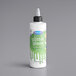 A container of Satin Ice Green Vanilla Glitter Glaze with a white label and black cap.