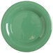 A close-up of a GET Diamond Mardi Gras rainforest green melamine plate with a white edge.