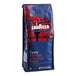 A blue bag of Lavazza Intenso ground coffee with red and white text and design.