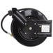 A black Equip by T&S metal hose reel with a hose attached.