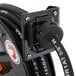 A close up of a black Equip by T&S hose on a hose reel.