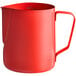 An Acopa red frothing pitcher with a handle.