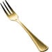 A close-up of the handle of a gold Bon Chef cocktail/oyster fork.