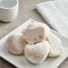 A white plate with My/Mochi Cookies and Cream Mochi Ice Cream on it.