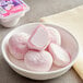 A close-up of pink and white My/Mochi Strawberry Mochi Ice Cream.