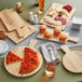 A slice of pizza on an Acopa Light Oak Faux Wood Melamine serving board.