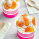 Two cups of ice cream with Kervan Sugared Gummy Orange Slices on top.