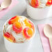 Two cups of ice cream with Kervan Gummy Peach Rings on top.