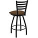 A Holland Bar Stool Jackie Ladderback Swivel Bar Stool with a brown cushion on a table in a bar.