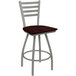 A Holland Bar Stool Jackie Ladderback Swivel Bar Stool with a dark cherry oak seat and an anodized nickel frame.