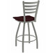 A Holland Bar Stool Jackie ladderback swivel bar stool with a dark cherry oak seat and back.