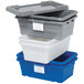 A gray Quantum lid on three stack of gray plastic containers.