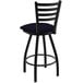 A black Holland Bar Stool Ladderback Swivel Bar Stool with a blue cushion.