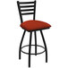 A black Holland Bar Stool ladderback swivel bar stool with a red and black graph poppy cushion.