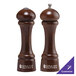 Two Chef Specialties Windsor Walnut pepper mills on a table.