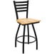 A black bar stool with a natural maple wooden seat.