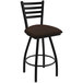 A black Holland Bar Stool Jackie Ladderback Swivel bar stool with a brown cushion.