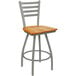 A Holland Bar Stool Jackie Ladderback Swivel Bar Stool with a medium oak seat and an anodized nickel finish.