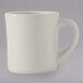 A Tuxton eggshell white china mug with a handle.