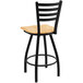A Holland Bar Stool Jackie Ladderback Swivel Bar Stool with a black frame and natural oak seat.