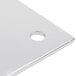 A white metal plate with a circular hole in it.