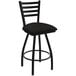 A black Holland Bar Stool ladderback swivel bar stool with a black cushion.