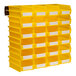 A yellow wall storage bin with compartments filled with white paper.