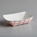 A white paper food tray with red and white checkered pattern.