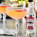 Two cocktails made with Fee Brothers Rose Water on a table in a cocktail bar.