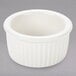 A white ceramic Tuxton fluted ramekin with a ribbed rim.