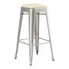 A Lancaster Table & Seating silver metal backless barstool with a white cushion on the seat.