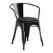 A Lancaster Table & Seating black metal arm chair with a black cushion.