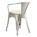A Lancaster Table & Seating metal arm chair with a white cushion.