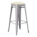 A Lancaster Table & Seating gray metal barstool with a white cushion seat.