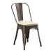 A brown metal Lancaster Table & Seating cafe chair with a white cushion.