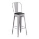 A Lancaster Table & Seating gray metal barstool with black cushion.