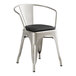 A Lancaster Table & Seating metal armchair with a black vinyl cushion.