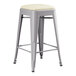 A Lancaster Table & Seating gray metal backless counter height stool with a white cushion seat.