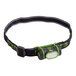 A black and green PowerSmith headlamp with a light on it and a white background.