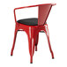 A red Lancaster Table & Seating metal arm chair with a black cushion.