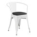 A Lancaster Table & Seating white metal arm chair with black cushion.