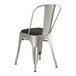 A Lancaster Table & Seating metal chair with black cushion.